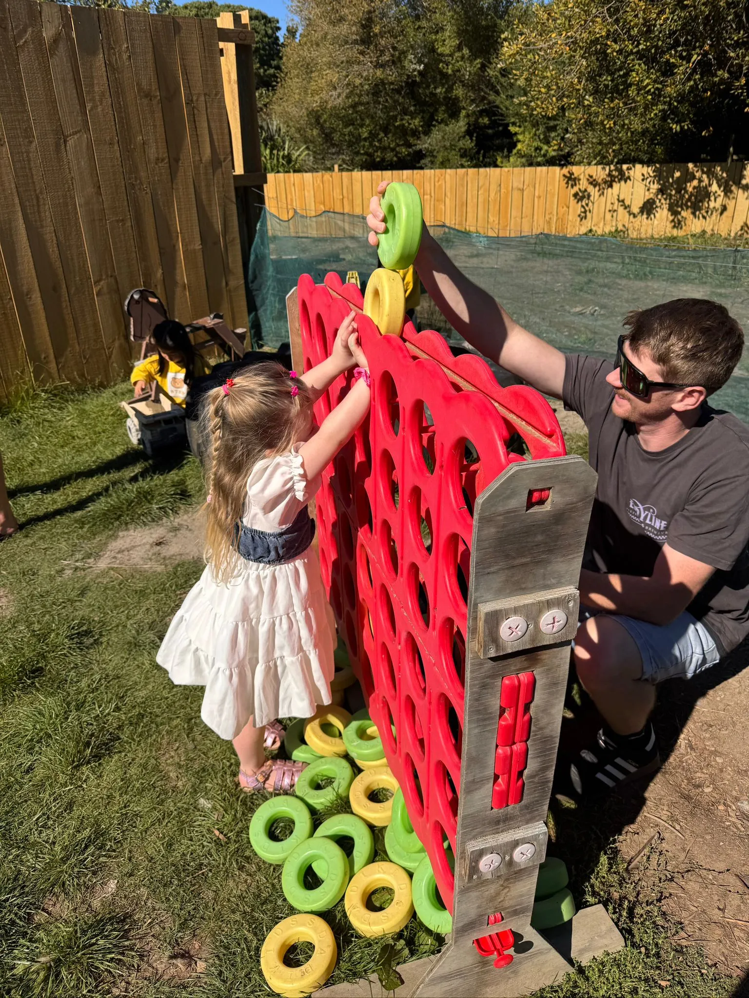 Michael playing giant Connect 4 with his daughter